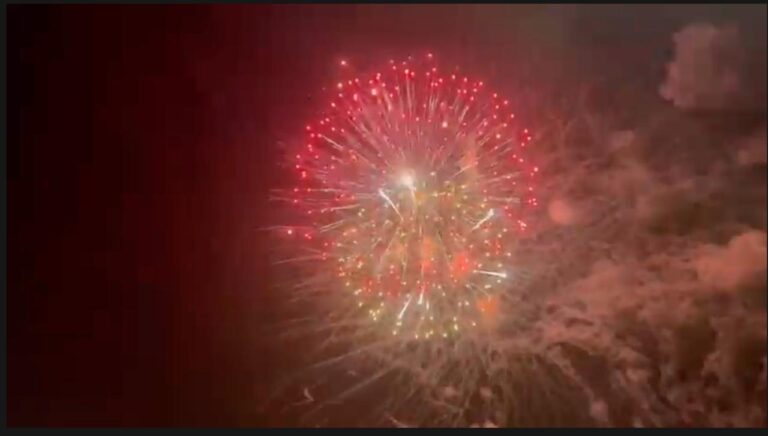 Keskiyön ilotulitukset Turun yötaivaalla, taustalla kaupunkimaisema ja ihmiset seuraamassa juhlaa.